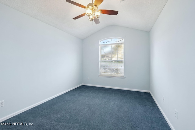 carpeted spare room featuring ceiling fan, vaulted ceiling, and a textured ceiling