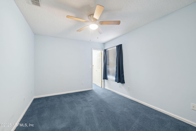 carpeted spare room with ceiling fan and a textured ceiling