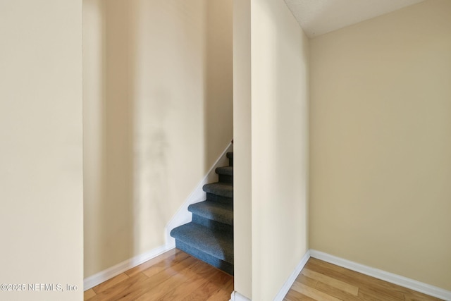 stairway featuring hardwood / wood-style flooring