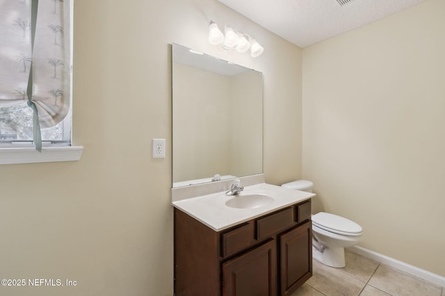 bathroom with vanity, tile patterned floors, and toilet