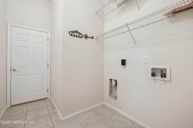 clothes washing area featuring light tile patterned floors, hookup for a washing machine, and hookup for an electric dryer