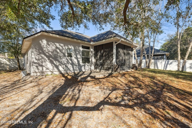 rear view of property with a sunroom