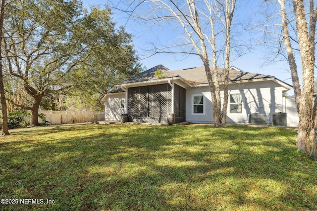 rear view of house featuring a yard and cooling unit