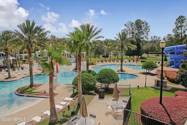 view of pool featuring a water slide and a patio