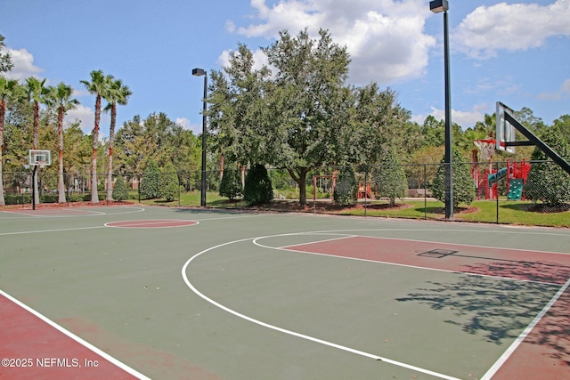 view of basketball court with a playground