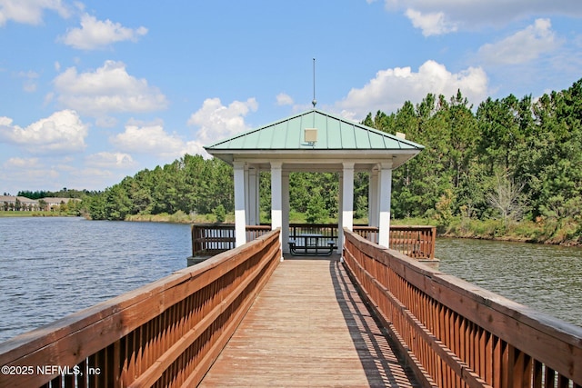 view of dock with a gazebo and a water view