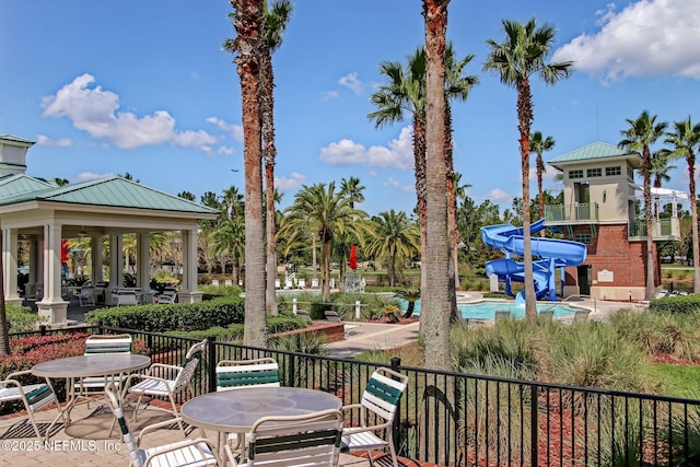 view of patio / terrace with a community pool and a gazebo