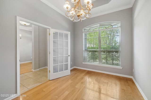 829 Songbird Dr, Orange Park, FL 32065 - spare room with a healthy amount of sunlight, wood finished floors, a notable chandelier, and ornamental molding