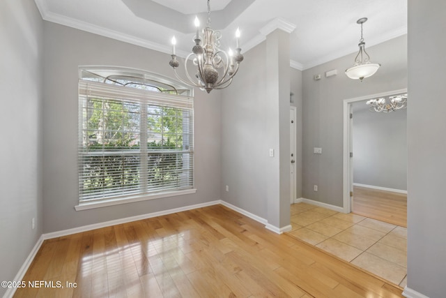 829 Songbird Dr, Orange Park, FL 32065 - unfurnished dining area featuring crown molding, baseboards, an inviting chandelier, and light wood-style floors