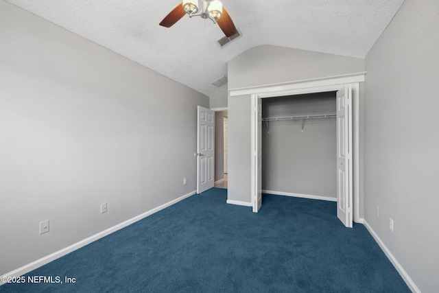 829 Songbird Dr, Orange Park, FL 32065 - unfurnished bedroom featuring a closet, dark colored carpet, ceiling fan, a textured ceiling, and vaulted ceiling