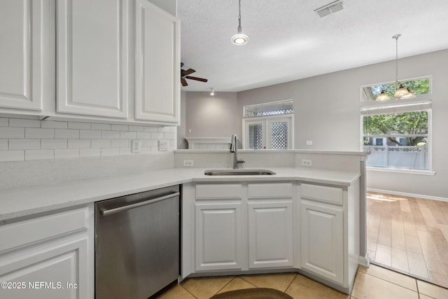 829 Songbird Dr, Orange Park, FL 32065 - kitchen featuring ceiling fan, stainless steel dishwasher, a sink, and white cabinets