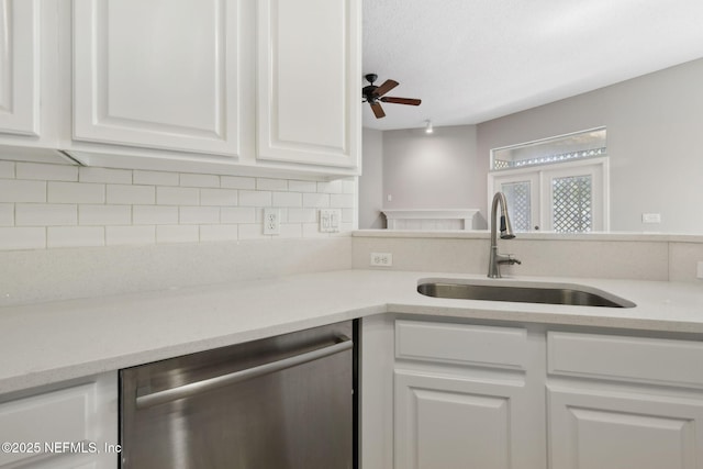 829 Songbird Dr, Orange Park, FL 32065 - kitchen with light countertops, dishwasher, a sink, and white cabinets