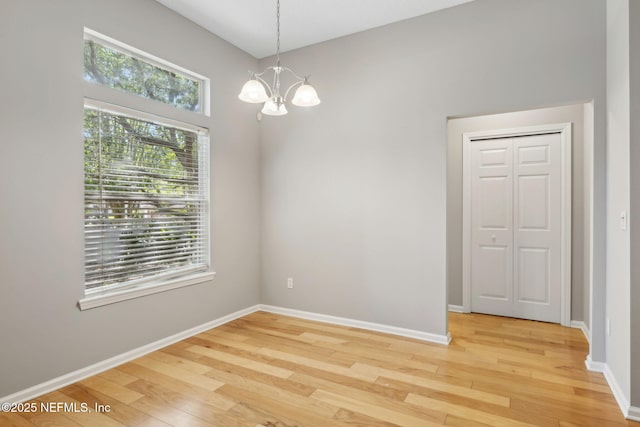 829 Songbird Dr, Orange Park, FL 32065 - empty room with a chandelier, light wood-type flooring, and a wealth of natural light
