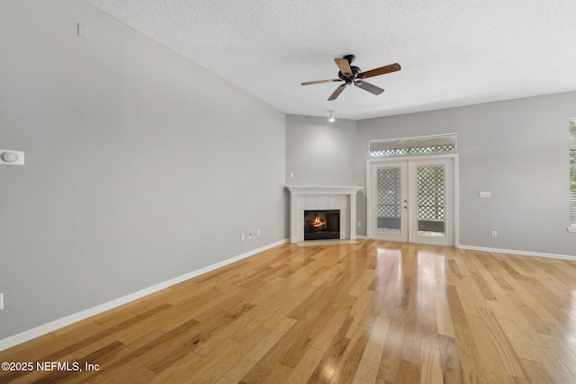 829 Songbird Dr, Orange Park, FL 32065 - unfurnished living room featuring baseboards, light wood-type flooring, and a ceiling fan