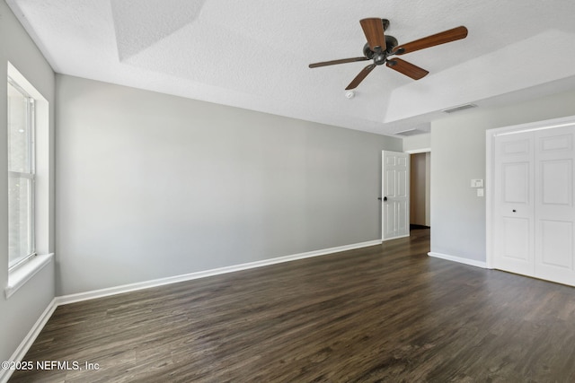 829 Songbird Dr, Orange Park, FL 32065 - unfurnished bedroom with visible vents, baseboards, a closet, a textured ceiling, and dark wood finished floors