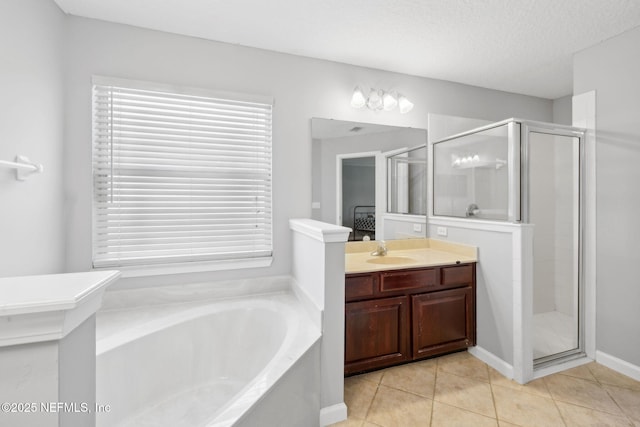 829 Songbird Dr, Orange Park, FL 32065 - bathroom featuring a bath, a textured ceiling, a shower stall, vanity, and tile patterned floors