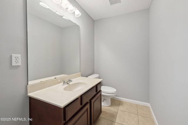 829 Songbird Dr, Orange Park, FL 32065 - half bathroom featuring visible vents, baseboards, toilet, vanity, and tile patterned floors
