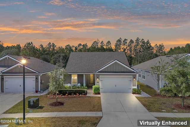 ranch-style home featuring a garage, a yard, and central AC unit