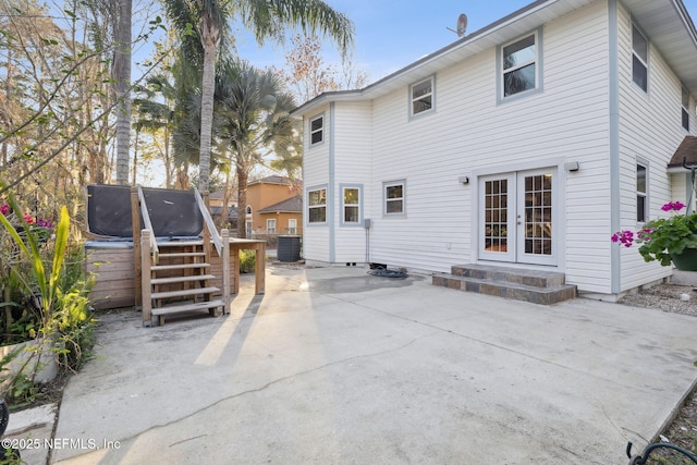 rear view of house featuring a patio area, french doors, and central air condition unit