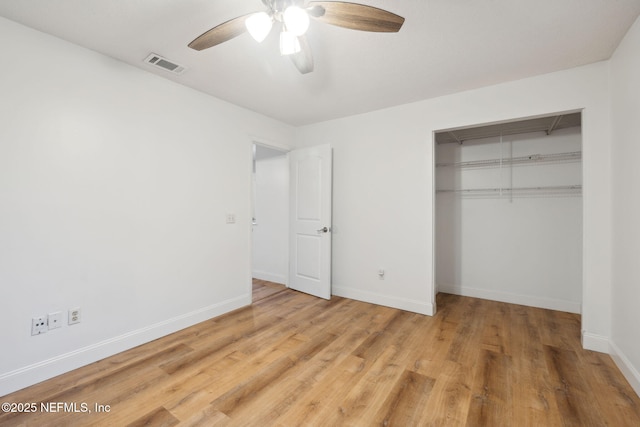 unfurnished bedroom with ceiling fan, a closet, and hardwood / wood-style floors