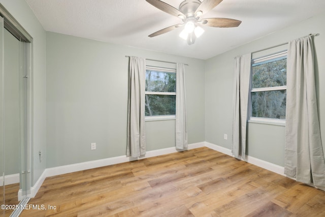 unfurnished bedroom featuring ceiling fan, a textured ceiling, and light hardwood / wood-style floors