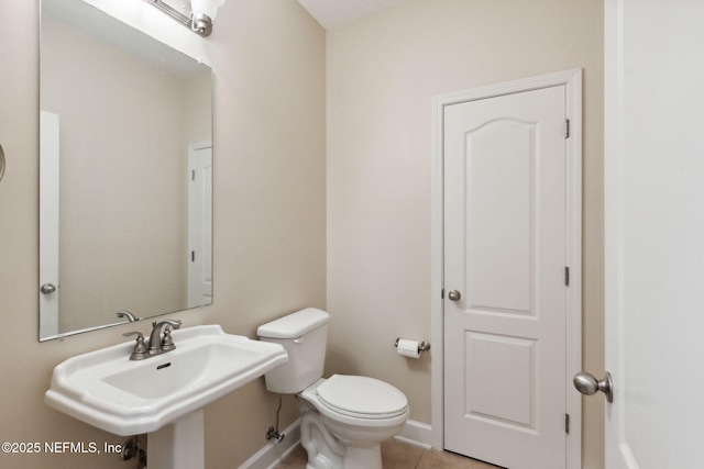 bathroom with tile patterned floors, toilet, and sink