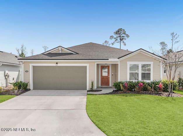 single story home featuring a garage and a front lawn