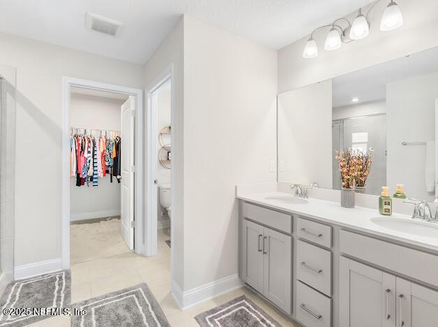 bathroom with vanity, toilet, and an enclosed shower