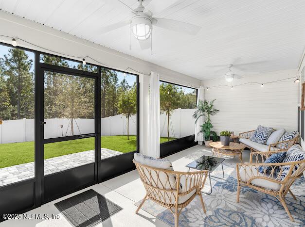 sunroom / solarium with ceiling fan