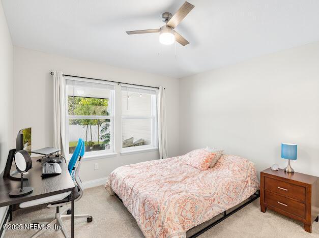 bedroom with light carpet and ceiling fan