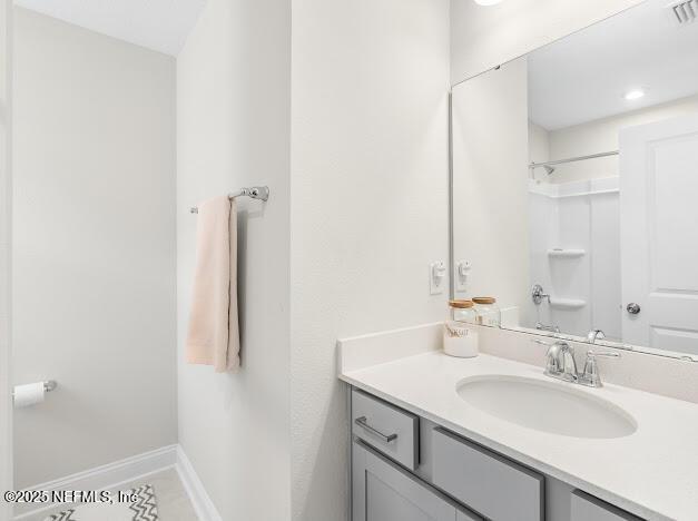 bathroom with vanity and walk in shower