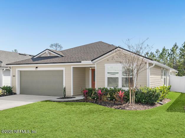 ranch-style home with a garage and a front yard