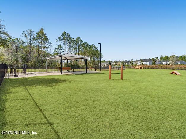 surrounding community with a gazebo and a yard