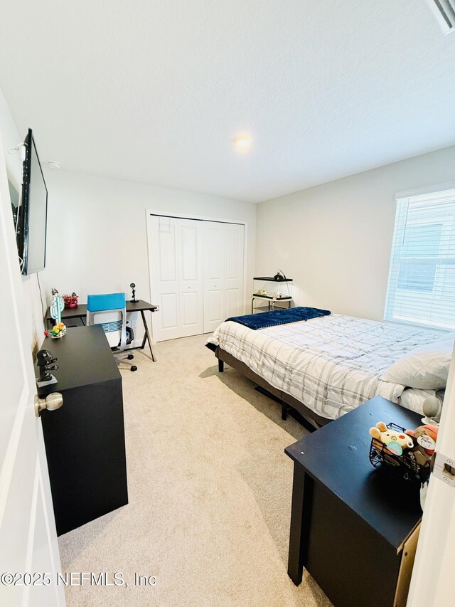 carpeted bedroom with a closet