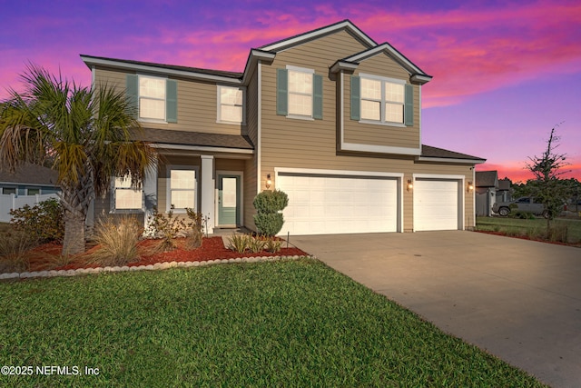 view of front of house with a garage and a lawn