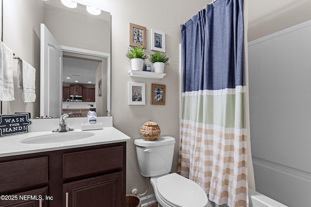 full bathroom featuring vanity, shower / tub combo, and toilet