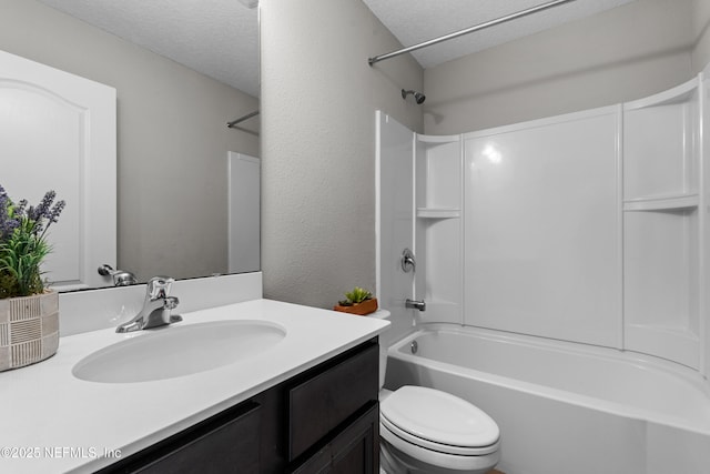 full bathroom with vanity, toilet, a textured ceiling, and washtub / shower combination