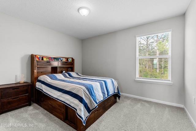 carpeted bedroom featuring a textured ceiling