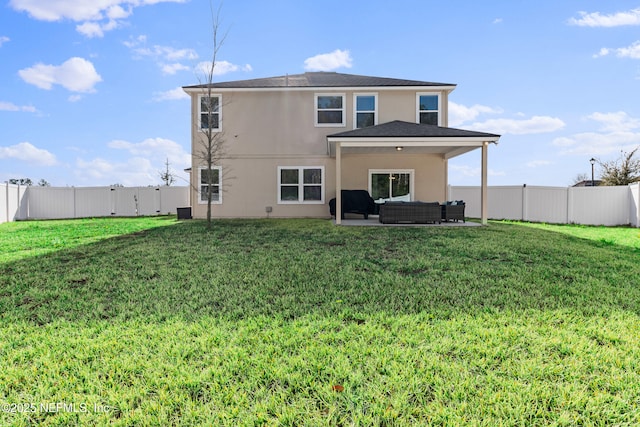 rear view of house with a yard, outdoor lounge area, and a patio area