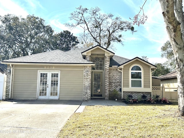 view of front facade with a front yard and french doors