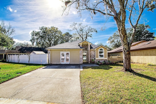 ranch-style house featuring a front yard and french doors