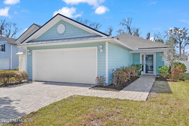 single story home featuring a garage and a front yard