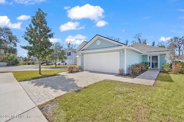 single story home featuring a garage and a front yard