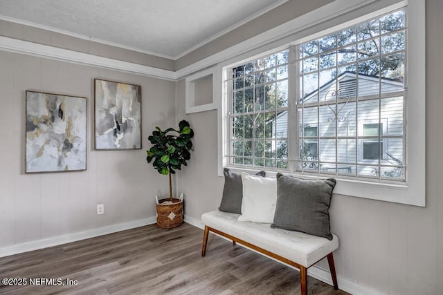 living area with ornamental molding, plenty of natural light, and hardwood / wood-style floors