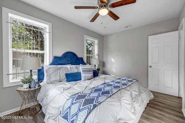 bedroom with ceiling fan and hardwood / wood-style floors