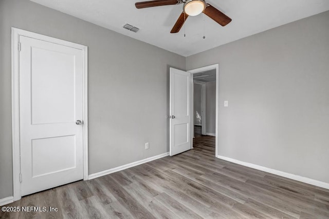 unfurnished bedroom featuring ceiling fan and light wood-type flooring