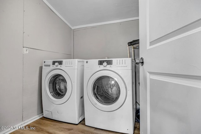 laundry room featuring light hardwood / wood-style floors and washing machine and dryer