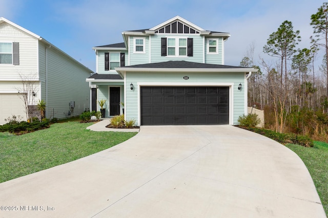 view of front of home with a garage and a front lawn