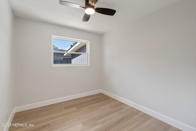 spare room featuring ceiling fan, light hardwood / wood-style floors, and a textured ceiling