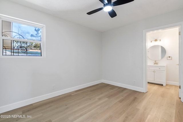 unfurnished bedroom featuring sink, connected bathroom, and light wood-type flooring